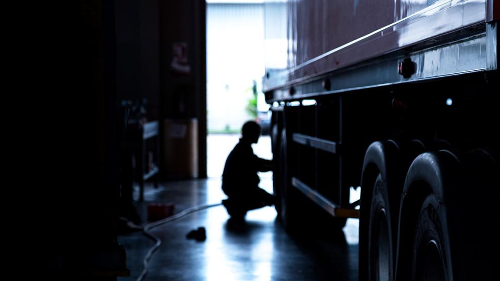 Person conducting maintenance on an electric truck